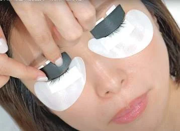 Eye patches being placed over a client’s lower lashes