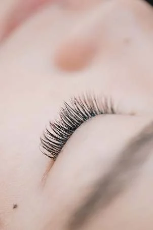 Long, full lash extensions on a closed eye
